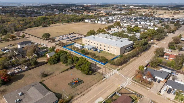 an aerial view of a residential houses with outdoor space