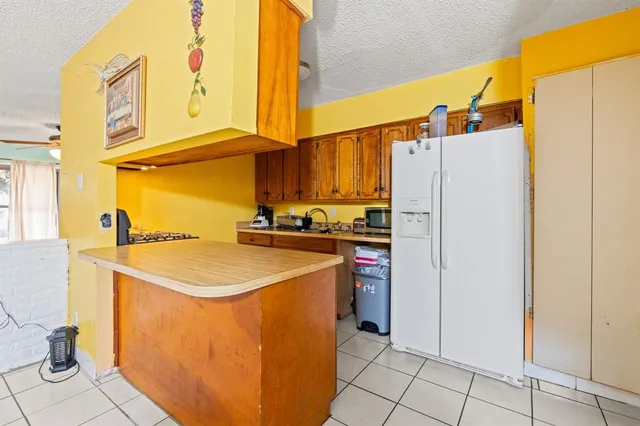 a kitchen with a sink a refrigerator and a stove