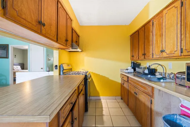 a kitchen with stainless steel appliances granite countertop a sink a stove and cabinets