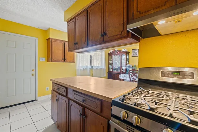 a kitchen with a wooden floor and a stove top oven