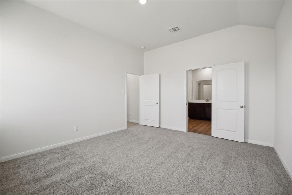 9908 Fighting Falcon Way Fort Worth, TX 76131 - Photo 19 of 22 a view of an empty room with a kitchen