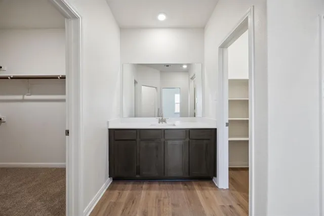 a view of an empty room with a kitchen