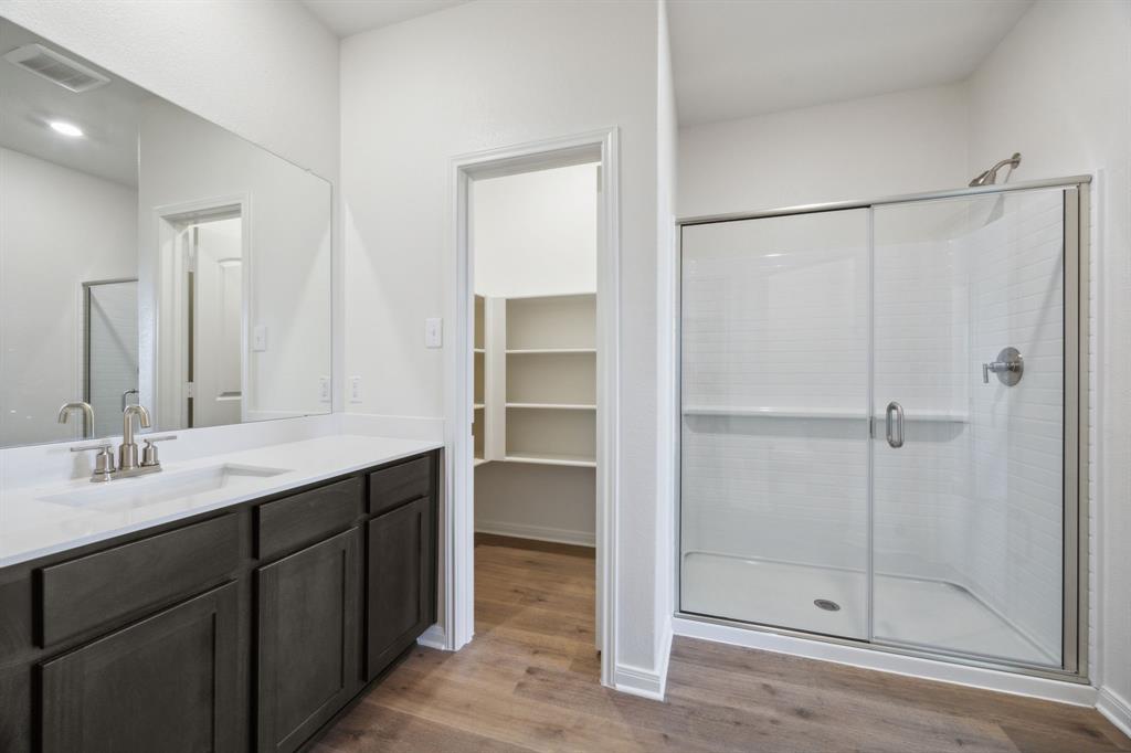 9908 Fighting Falcon Way Fort Worth, TX 76131 - Photo 21 of 22 a bathroom with a double vanity sink mirror and shower