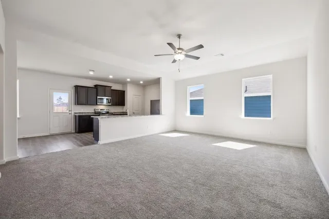 a view of a kitchen with a microwave and a stove top oven
