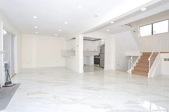 a view of empty room with wooden floor and windows