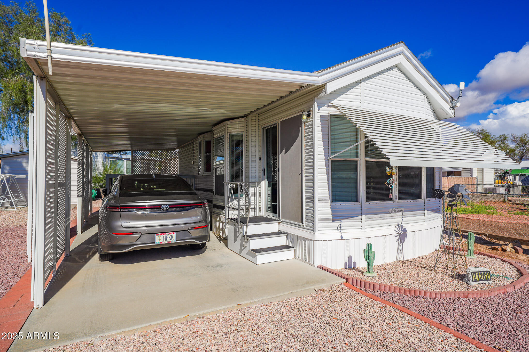 a view of a patio with couches table and chairs with wooden floor and fence