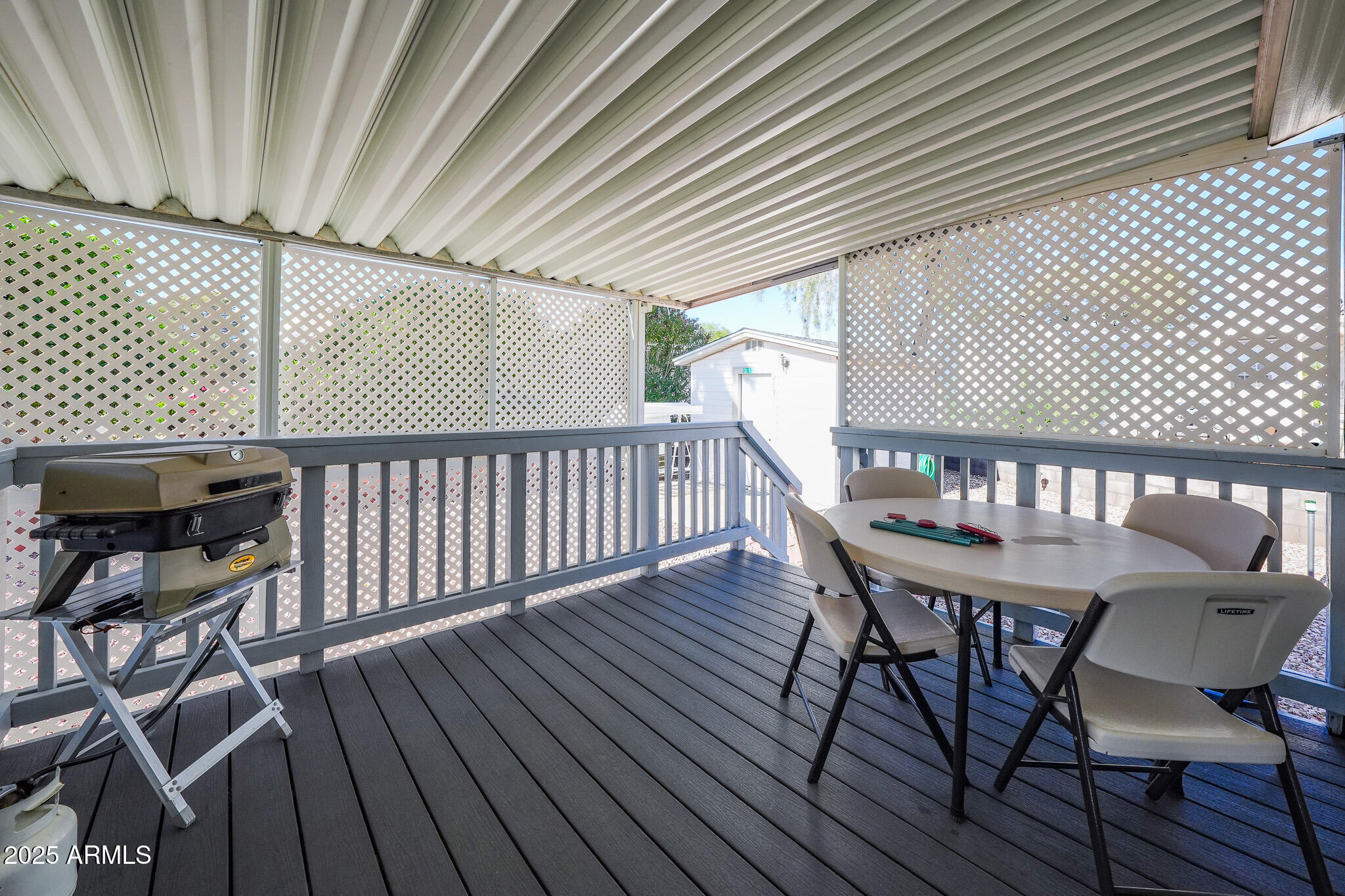 21282 Escapees Way, Unit 409 Congress, AZ 85332 - Photo 14 of 33 a view of a chairs and table on the wooden floor