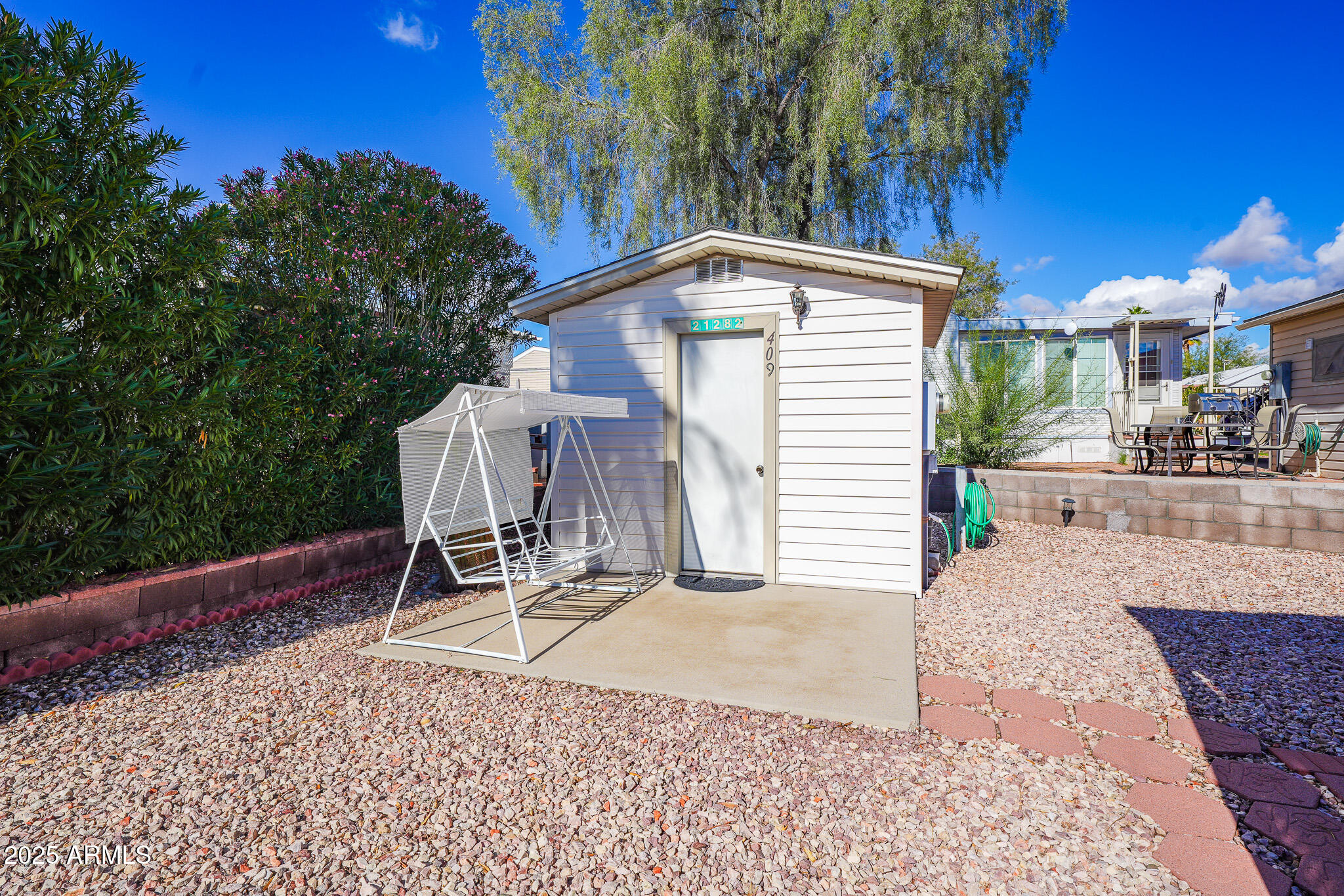 21282 Escapees Way, Unit 409 Congress, AZ 85332 - Photo 18 of 33 a view of a chair and table in the backyard