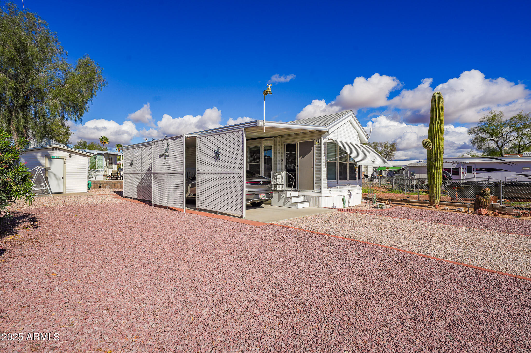 21282 Escapees Way, Unit 409 Congress, AZ 85332 - Photo 3 of 33 a view of a house with a backyard and balcony