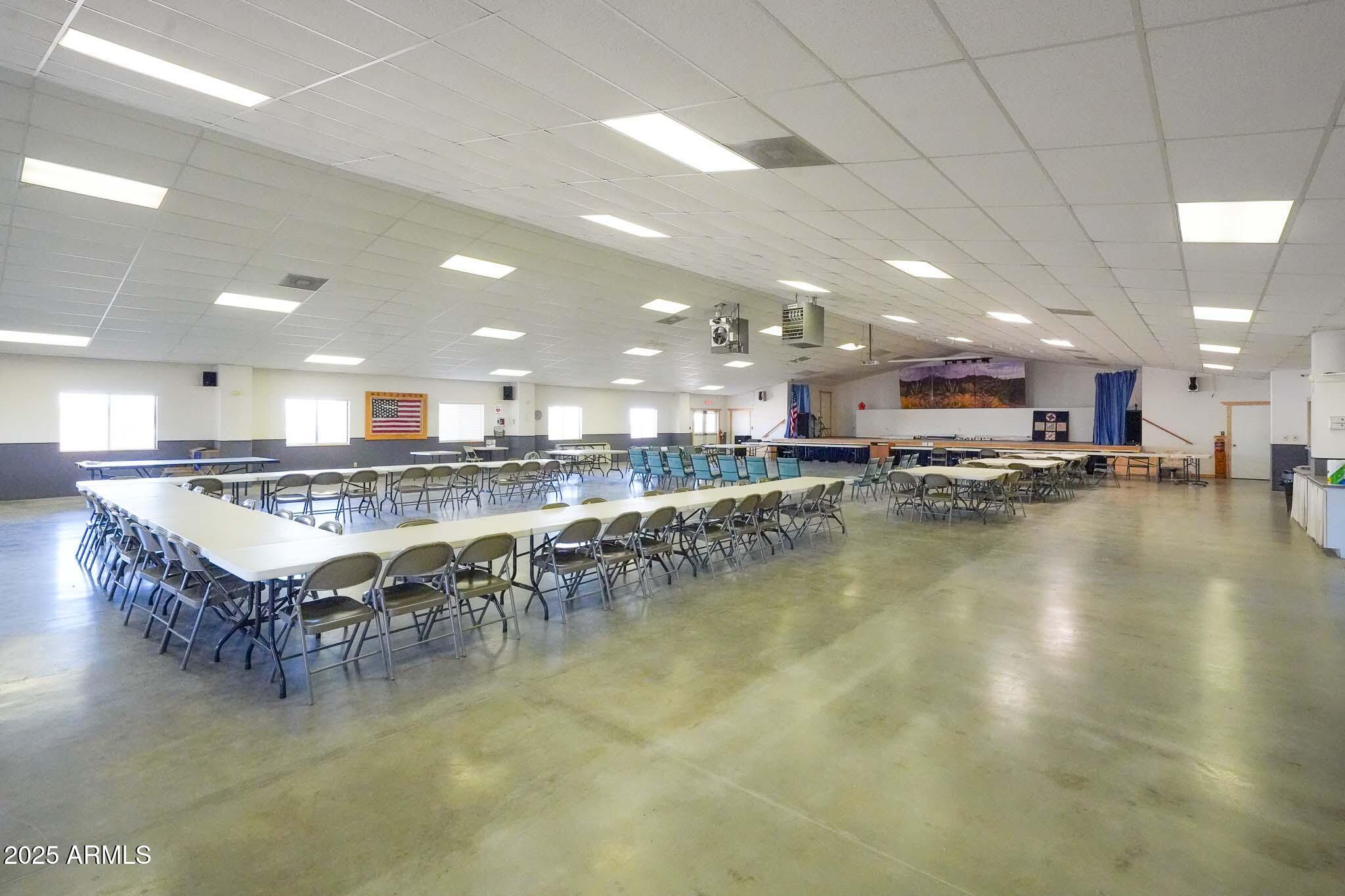 21282 Escapees Way, Unit 409 Congress, AZ 85332 - Photo 31 of 33 a kitchen with stainless steel appliances granite countertop a stove top oven a dining table and chairs