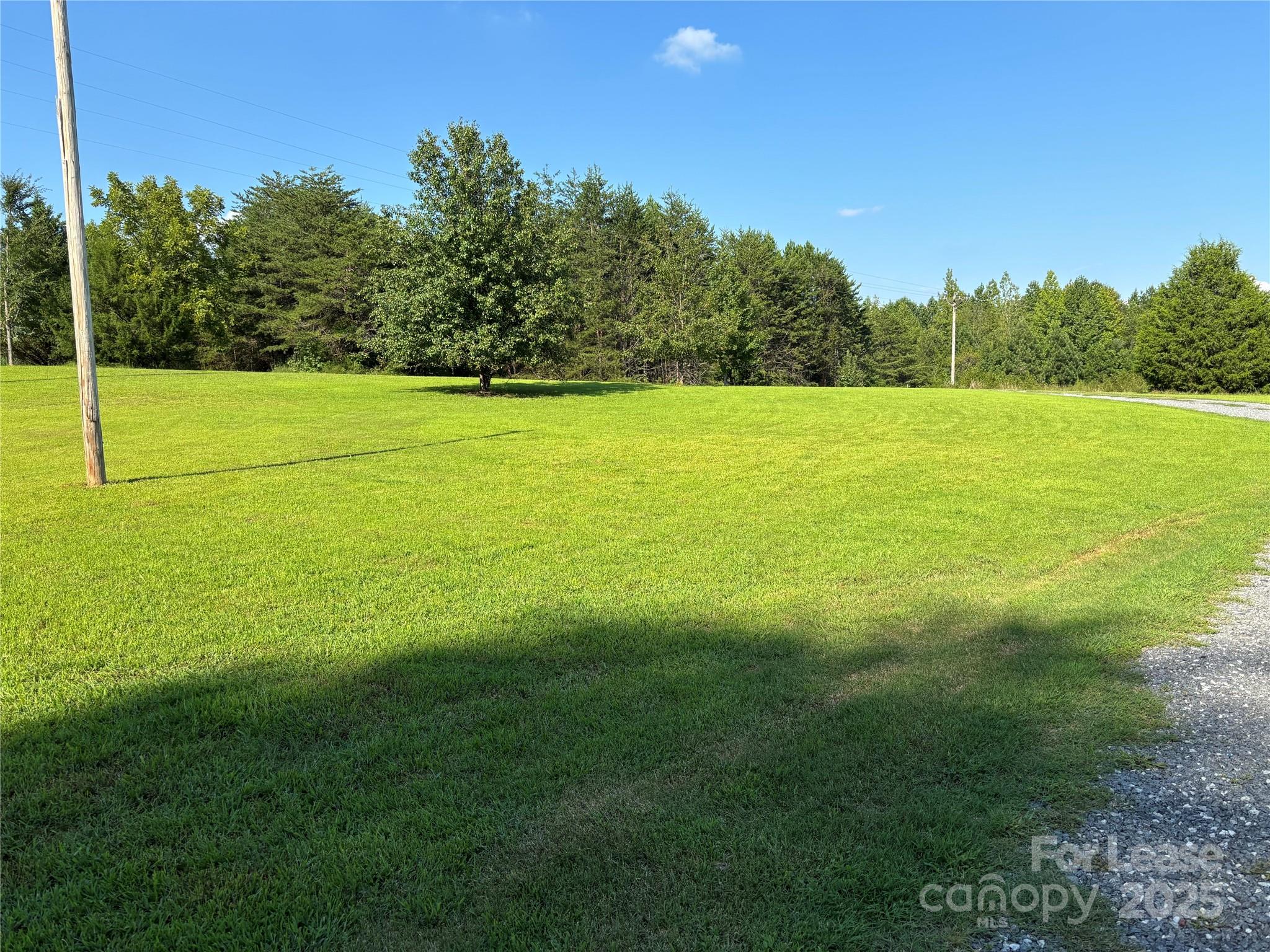 994 Wilma Sigmon Road Lincolnton, NC 28092 - Photo 4 of 15 a view of a field with trees in the background