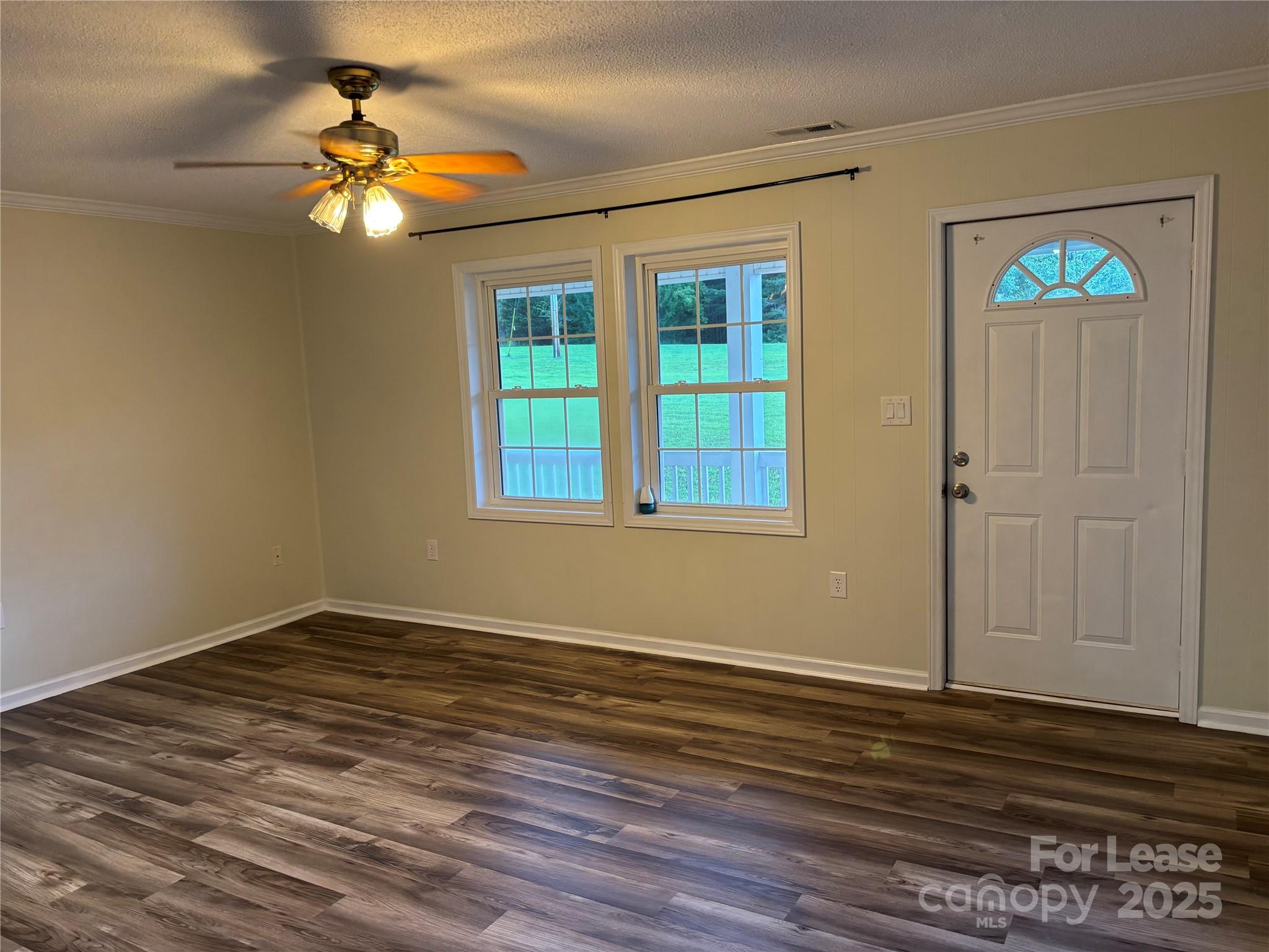 994 Wilma Sigmon Road Lincolnton, NC 28092 - Photo 5 of 15 a view of empty room with wooden floor and fan