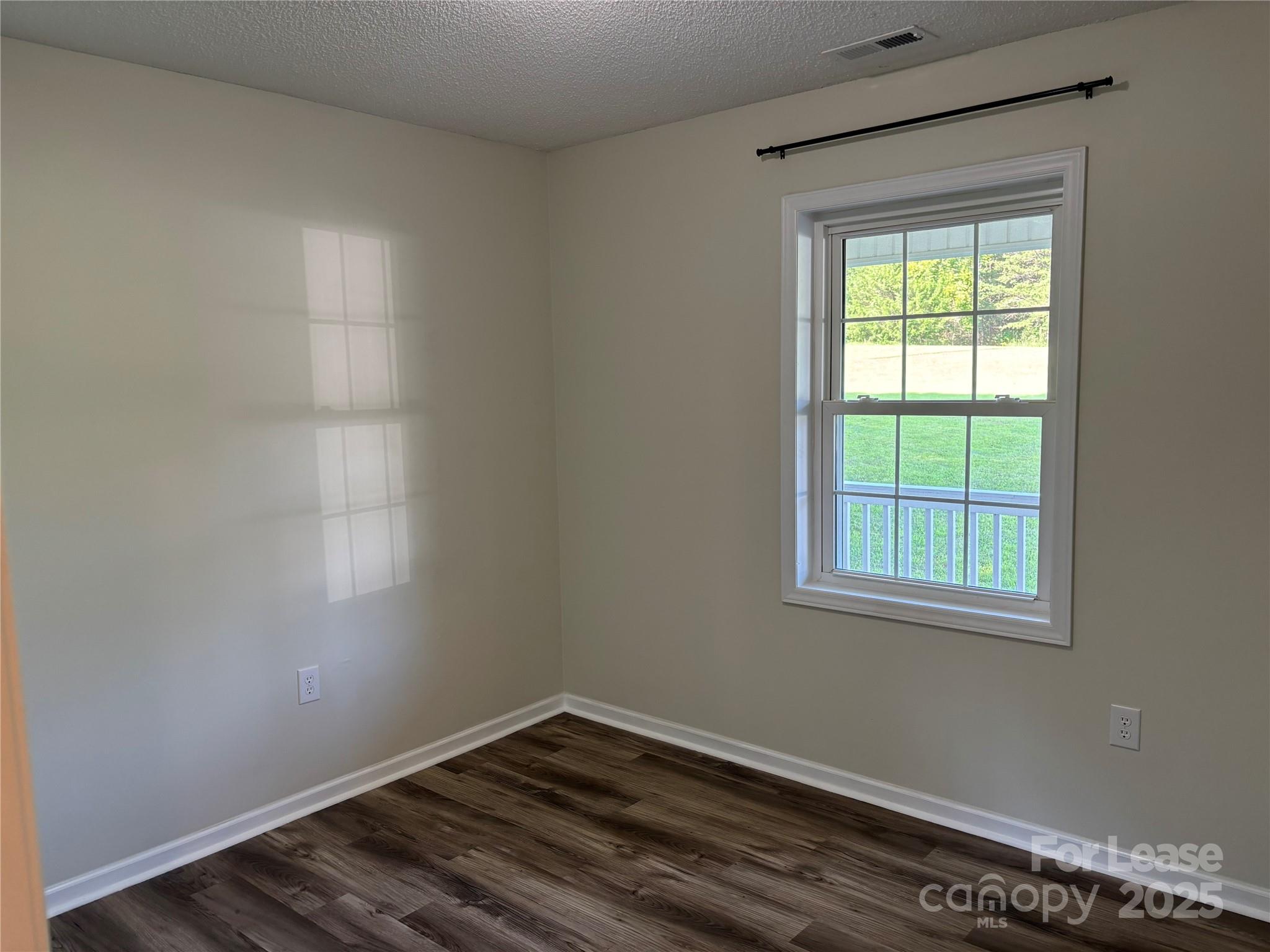 994 Wilma Sigmon Road Lincolnton, NC 28092 - Photo 8 of 15 a view of an empty room with wooden floor and a window
