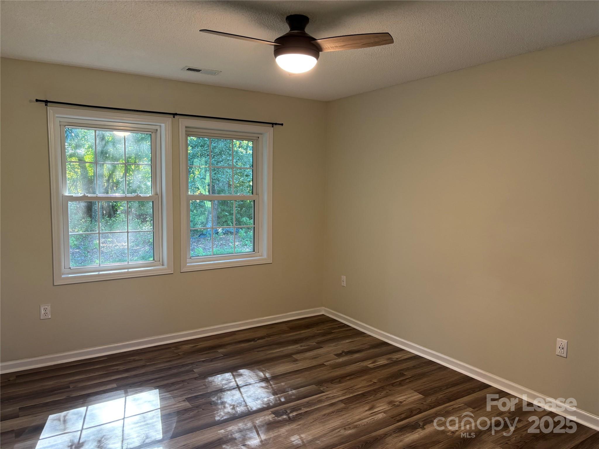 994 Wilma Sigmon Road Lincolnton, NC 28092 - Photo 9 of 15 a view of an empty room with wooden floor and a window
