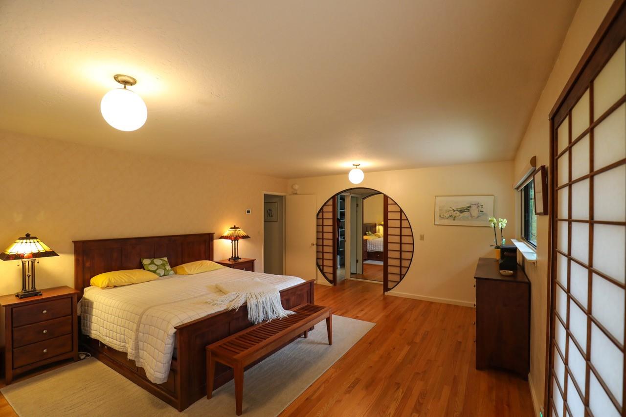 16 Westwood Road Santa Cruz, CA 95060 - Photo 25 of 46 a bed room with a bed and a chandelier