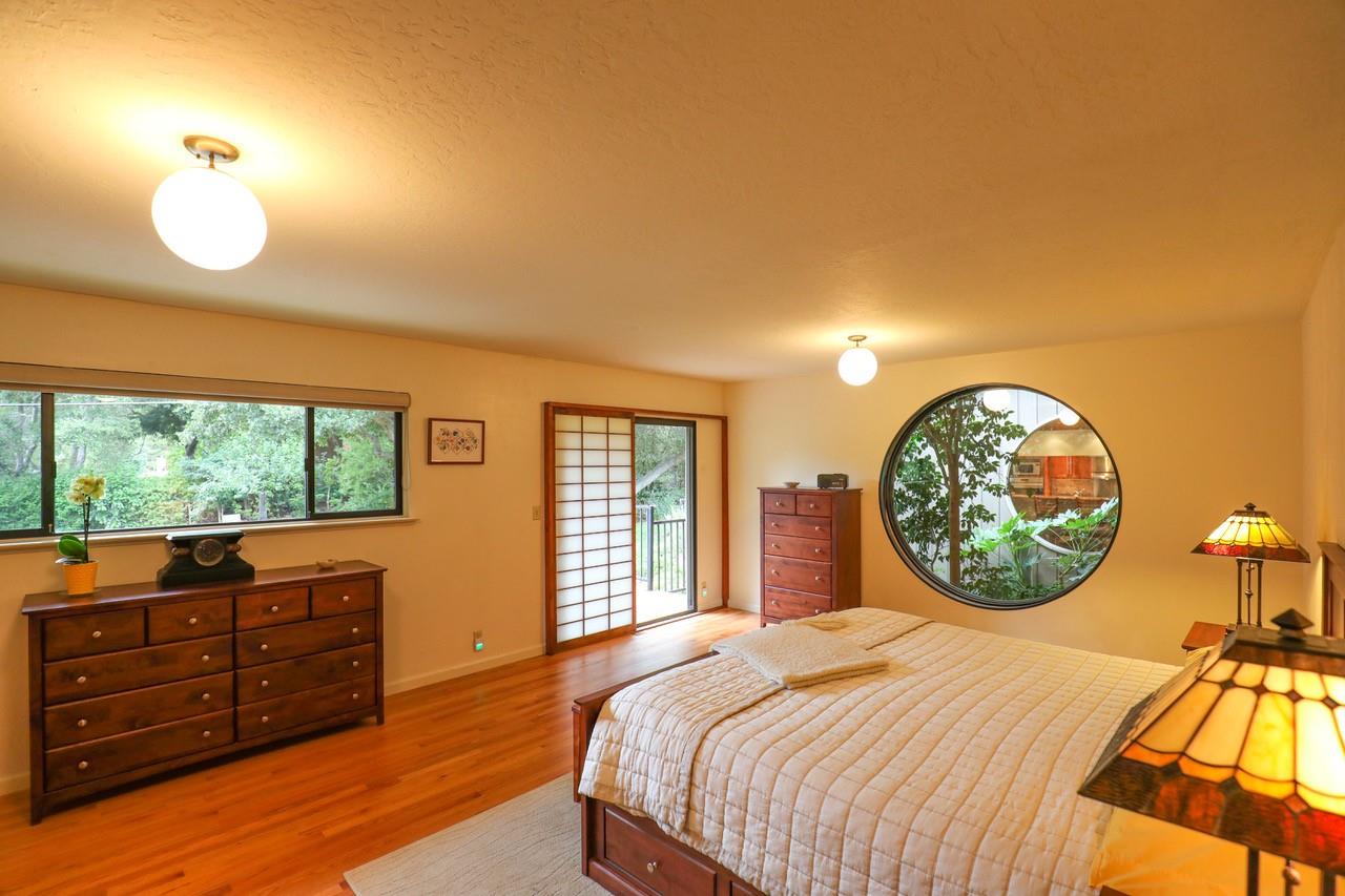 16 Westwood Road Santa Cruz, CA 95060 - Photo 27 of 46 a bedroom with a bed and dresser with mirror