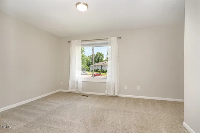 a kitchen with granite countertop white cabinets and stainless steel appliances