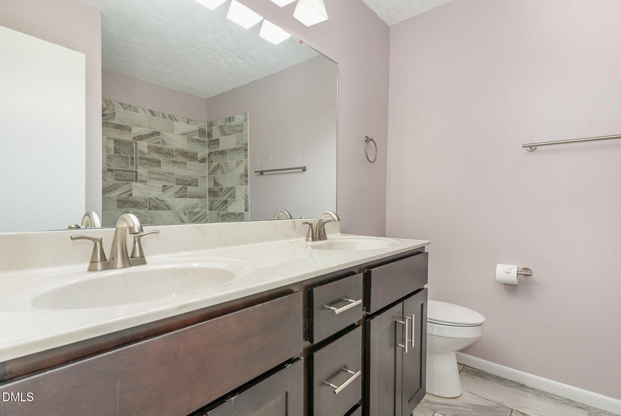 1304 Seaton Road, Unit 1 Durham, NC 27713 - Photo 14 of 20 a bathroom with a granite countertop sink a toilet and a mirror