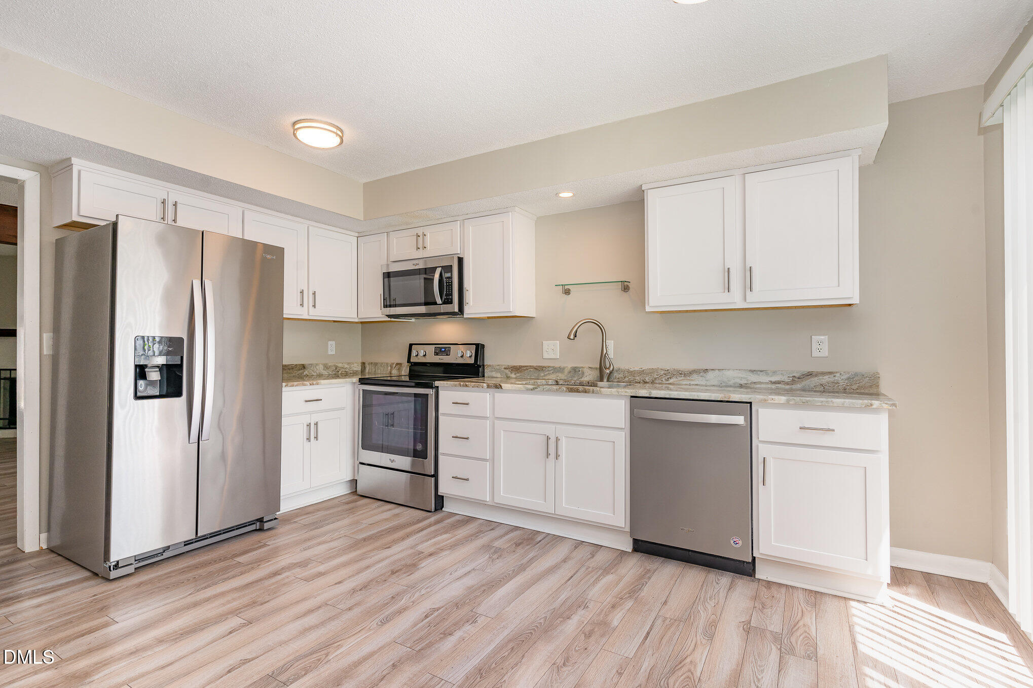 1304 Seaton Road, Unit 1 Durham, NC 27713 - Photo 6 of 20 a kitchen with granite countertop white cabinets and stainless steel appliances
