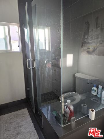 a bathroom with a toilet and a shower