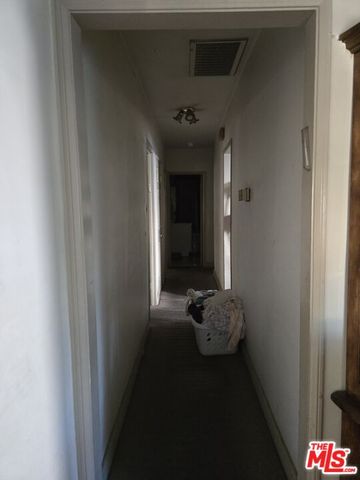 a hallway with a view of bedroom