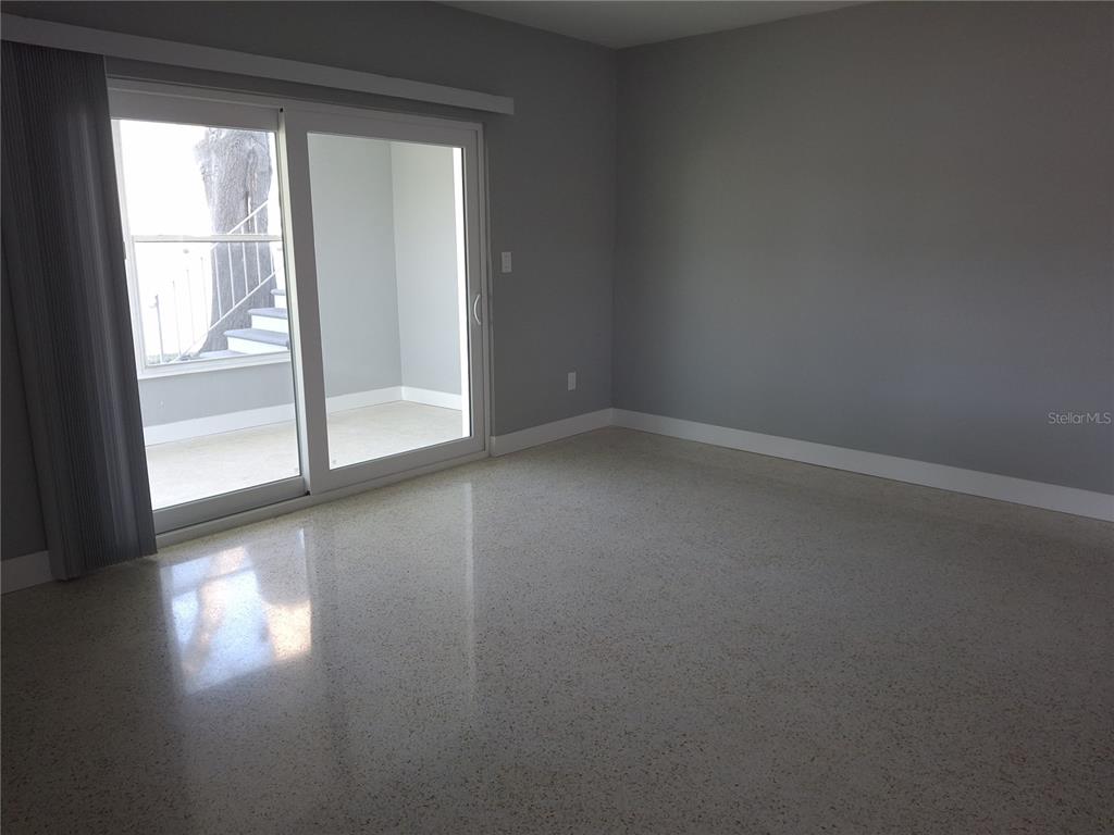 11355 3rd Street East Treasure Island, FL 33706 - Photo 7 of 19 a view of empty room with wooden floor and fan