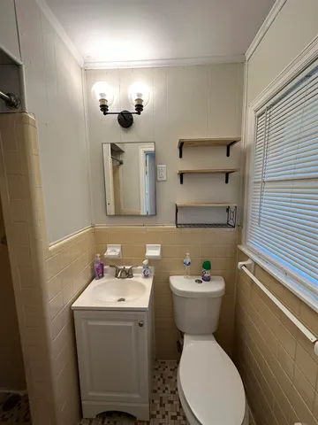 a bathroom with a sink toilet and mirror