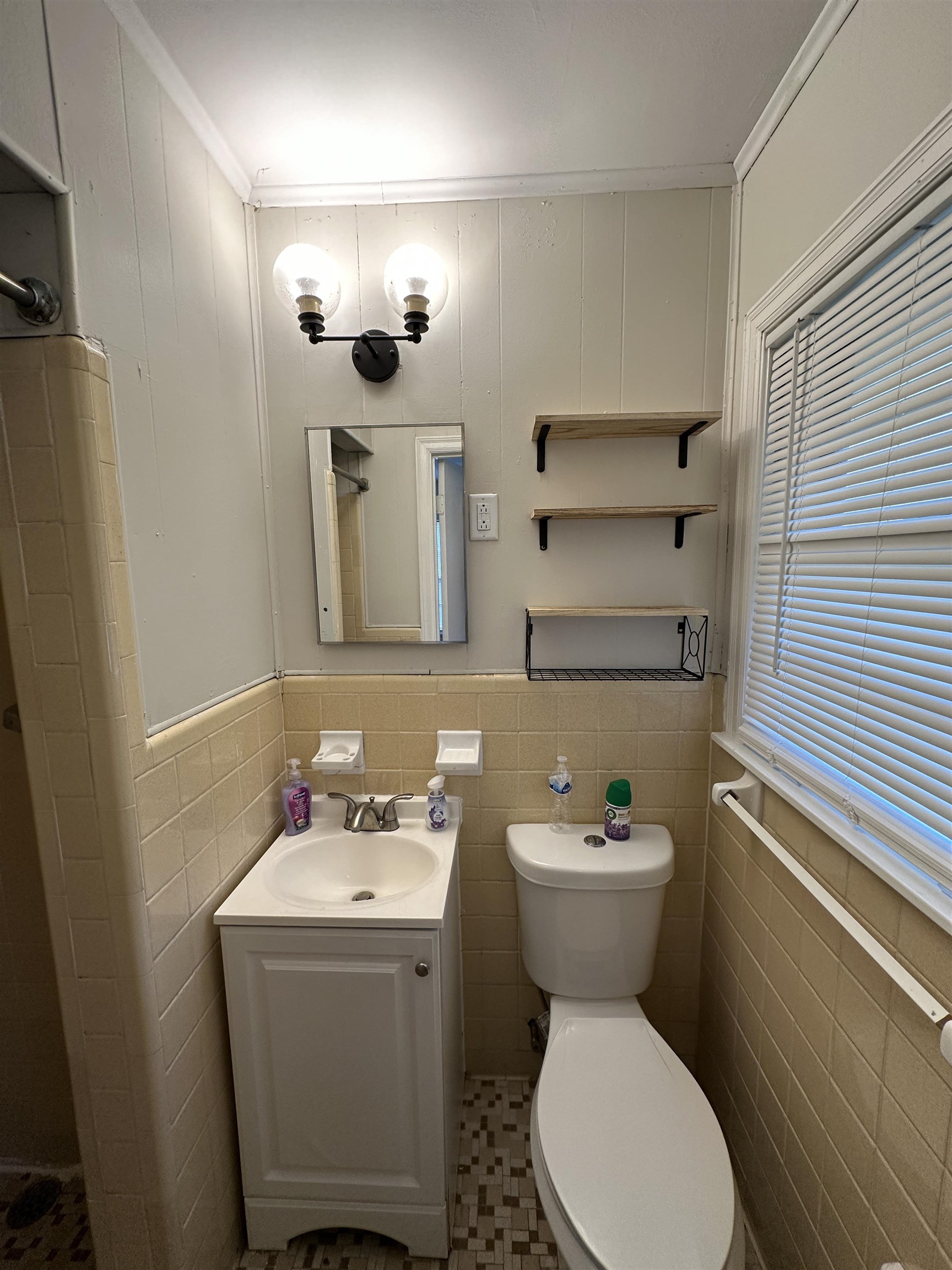 470 Dreger Road Memphis, TN 38109 - Photo 14 of 19 Half bath featuring vanity, tile walls, ornamental molding, and a wainscoted wall