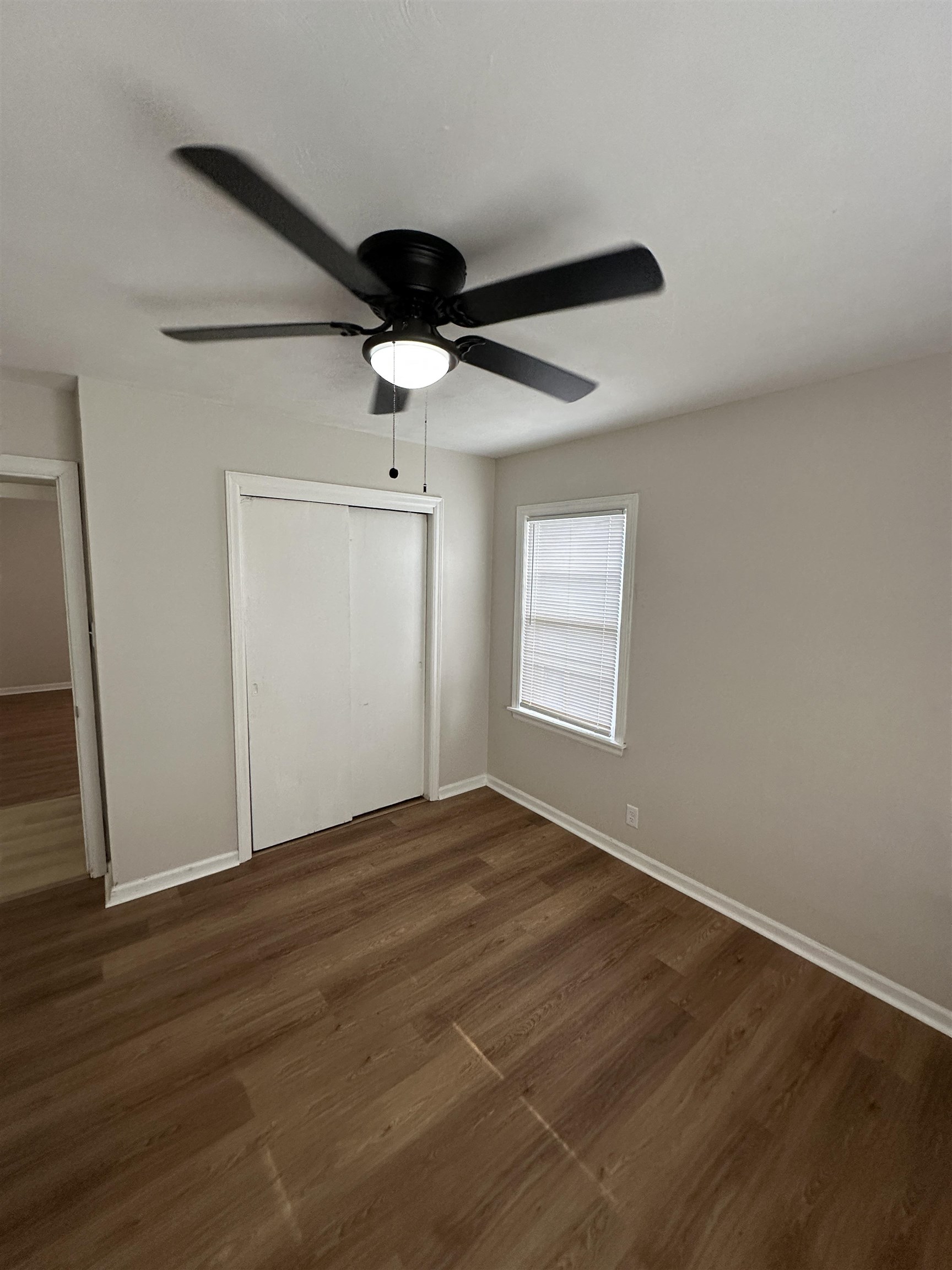 470 Dreger Road Memphis, TN 38109 - Photo 16 of 19 Unfurnished bedroom featuring a closet, a ceiling fan, and dark wood-style floors