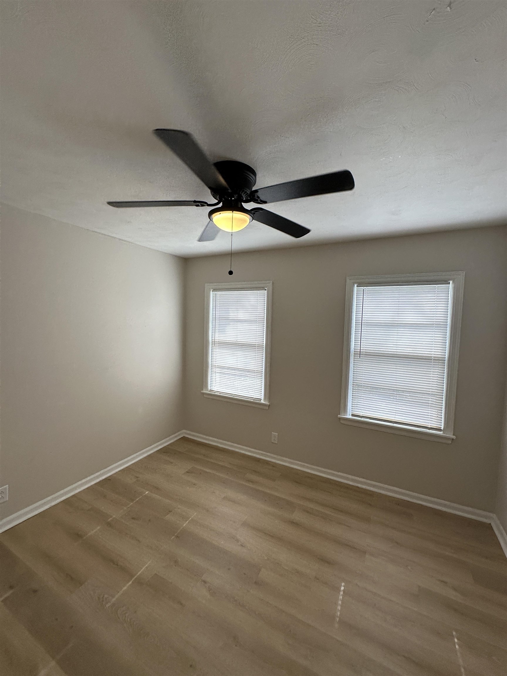 470 Dreger Road Memphis, TN 38109 - Photo 17 of 19 Empty room featuring a textured ceiling, light wood finished floors, and ceiling fan