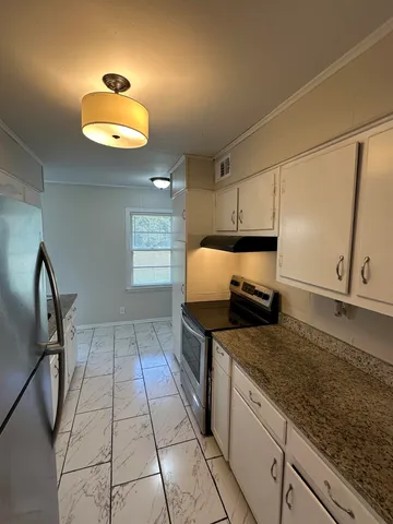 a kitchen with stainless steel appliances granite countertop a sink and cabinets