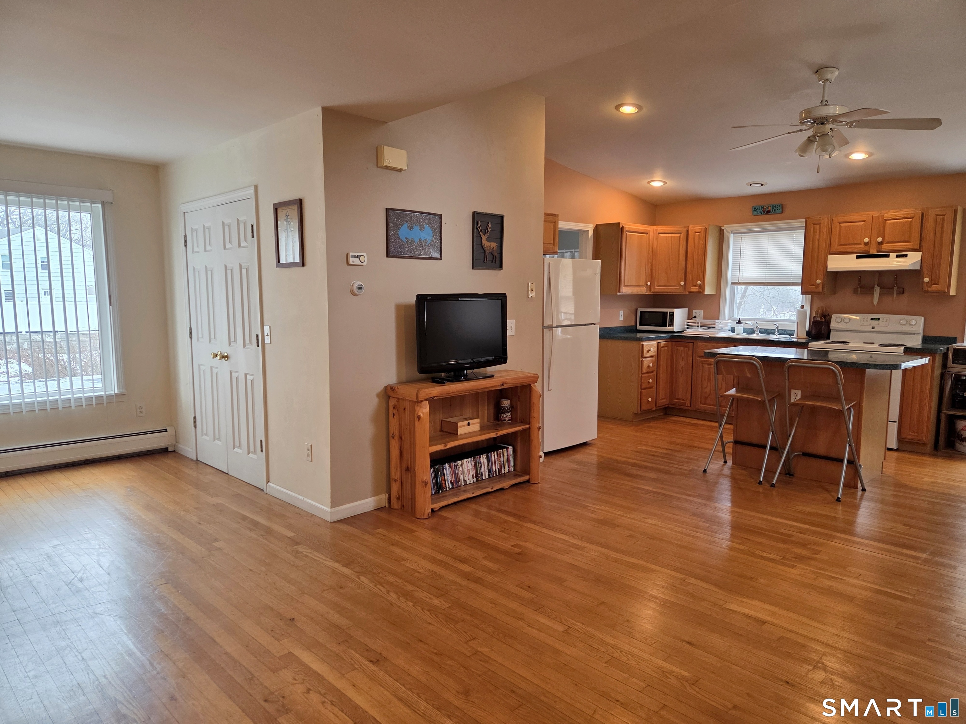 54 Benedict Street, Unit A Norwalk, CT 06850 - Photo 1 of 1 a living room with furniture and a flat screen tv