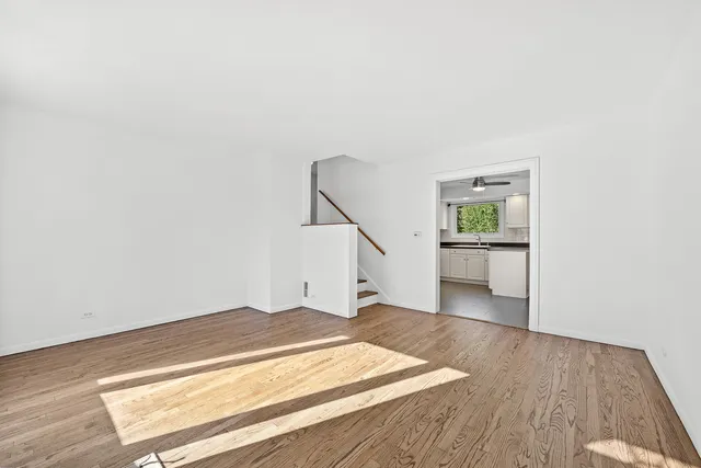 a view of an empty room and wooden floor
