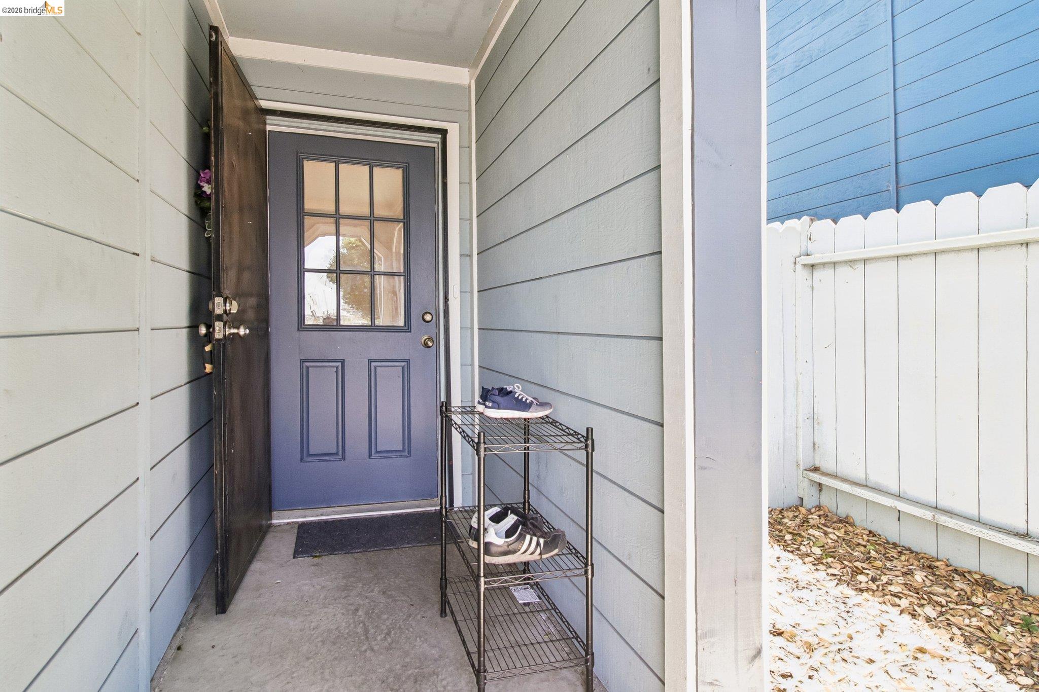 874 Pine Street Oakland, CA 94607 - Photo 2 of 39 Entryway featuring horizontal siding, a paneled door with divided lite glass, and a concrete landing