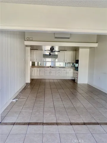 a kitchen with stainless steel appliances a cabinets and window