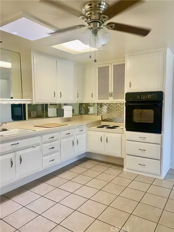a kitchen with sink and cabinets