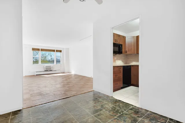 a view of a houses with yard and mountain view in back