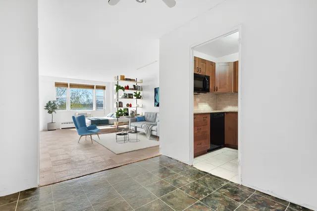a view of empty room with window and wooden floor