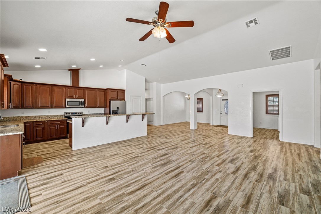 6720 Stubblefield Drive Pahrump, NV 89061 - Photo 9 of 51 An open-concept living area boasts a modern kitchen with ample cabinetry and a practical breakfast bar.