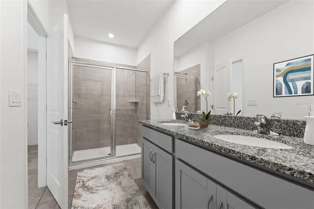 a bathroom with a granite countertop sink mirror and double