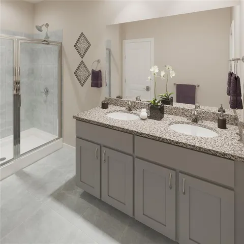 a bathroom with a granite countertop sink mirror and a shower