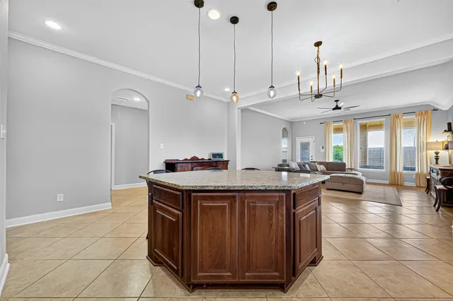 a kitchen with stainless steel appliances granite countertop a sink a stove and a wooden floors