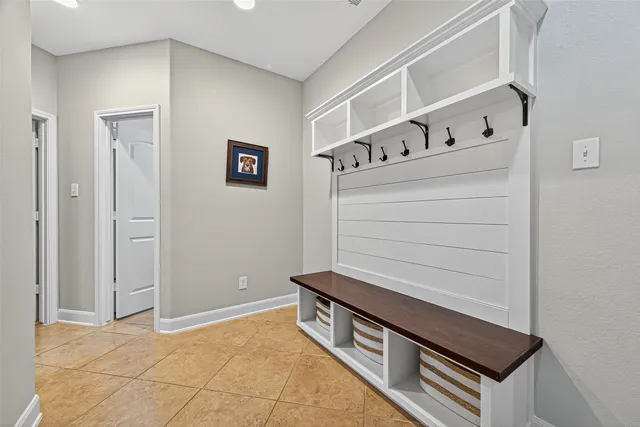 a spacious bedroom with a bed and a chandelier