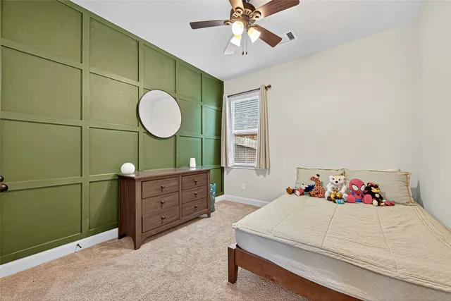 a bedroom with a bed and ceiling fan