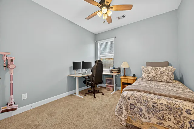 a bedroom with a workspace