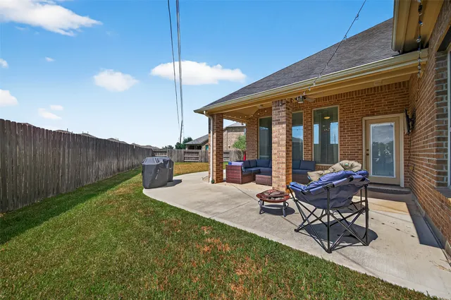 a backyard of a house with outdoor seating