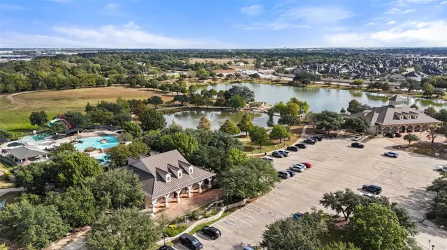 an aerial view of residential houses with outdoor space and swimming pool