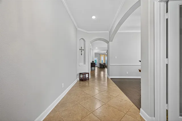 a view of a hallway with a dining table and chairs