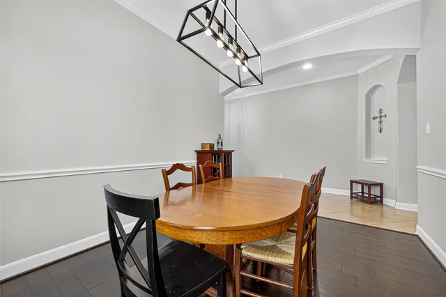 a dining room with furniture and wooden floor