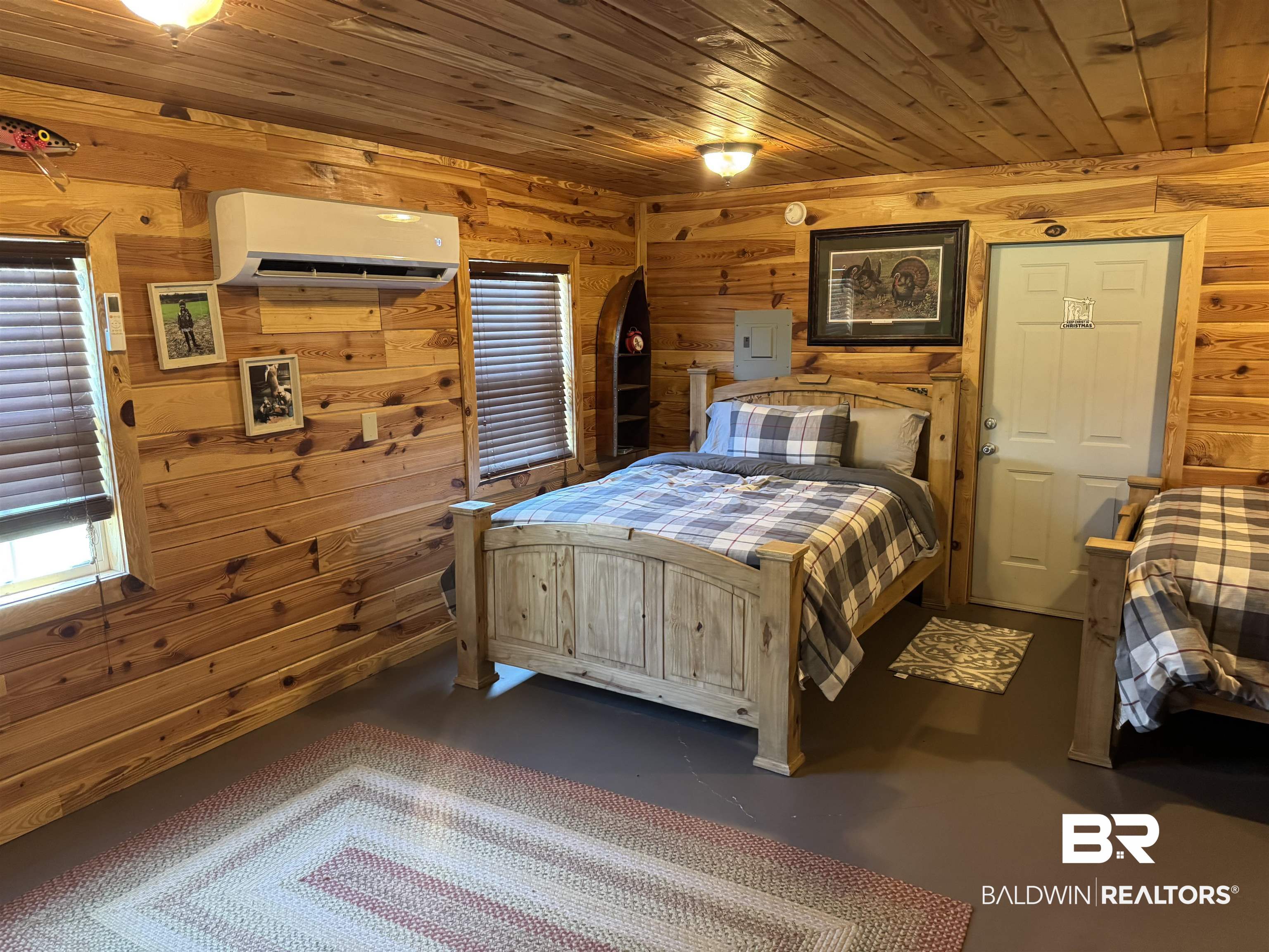 516 Mill Creek Road Frisco City, AL 36445 - Photo 9 of 32 Bedroom with wooden ceiling, wood walls, electric panel, and finished concrete floors